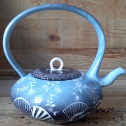 blue porcelain teapot with japanese design . handmade